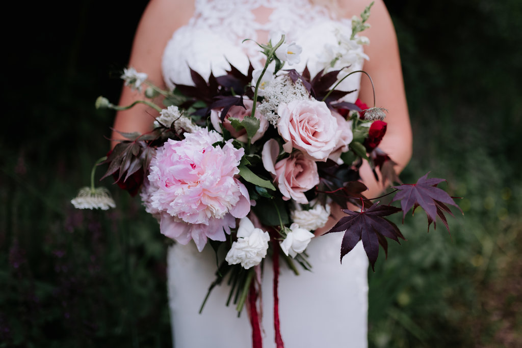 bride holding a beautiful wedding bouquet of flowers